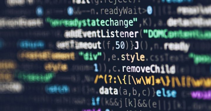 HTML CSS JavaScript source code displayed on a monitor representing CSS layout code